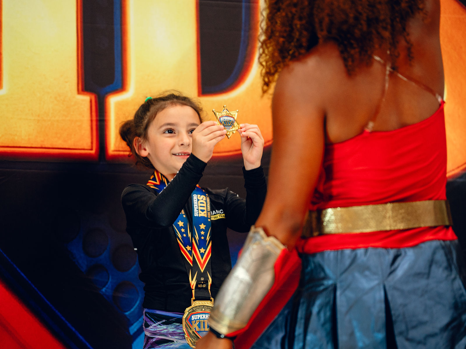 A young athlete kissing his medal